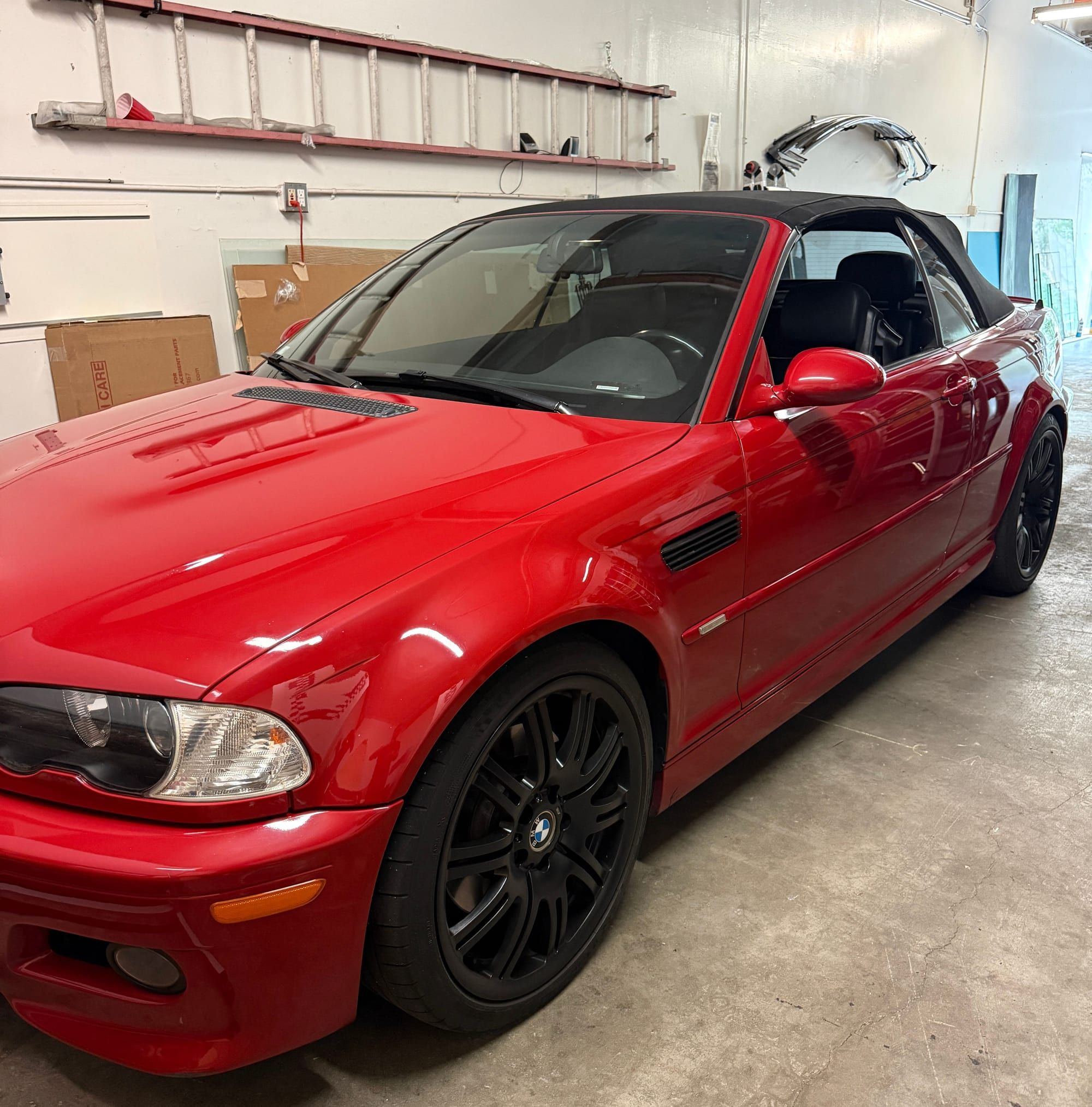Red BMW M3 convertible inside the Super Auto Glass shop
